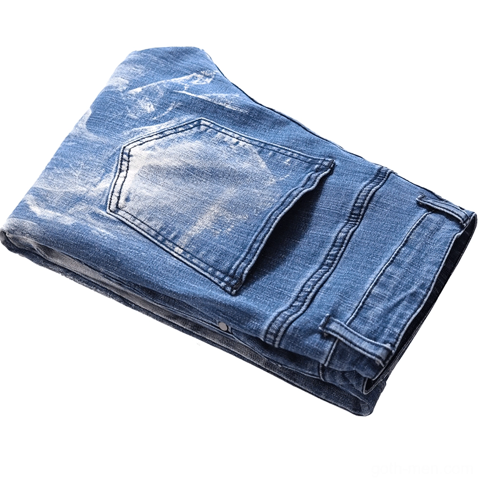 Folded men's light blue gothic jeans displaying side profile of 3D skull print and back pocket construction