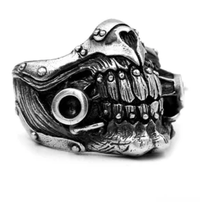 Gothic hollow skull mask ring with riveted armor details - left oblique front view showing antique silver finish