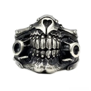 Punk rock statement skull ring front-facing view highlighting hollow circular side ports and combat design