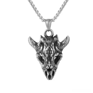 Skull necklace pendant hanging on stainless steel box chain showing three-dimensional form and oxidized metal texture