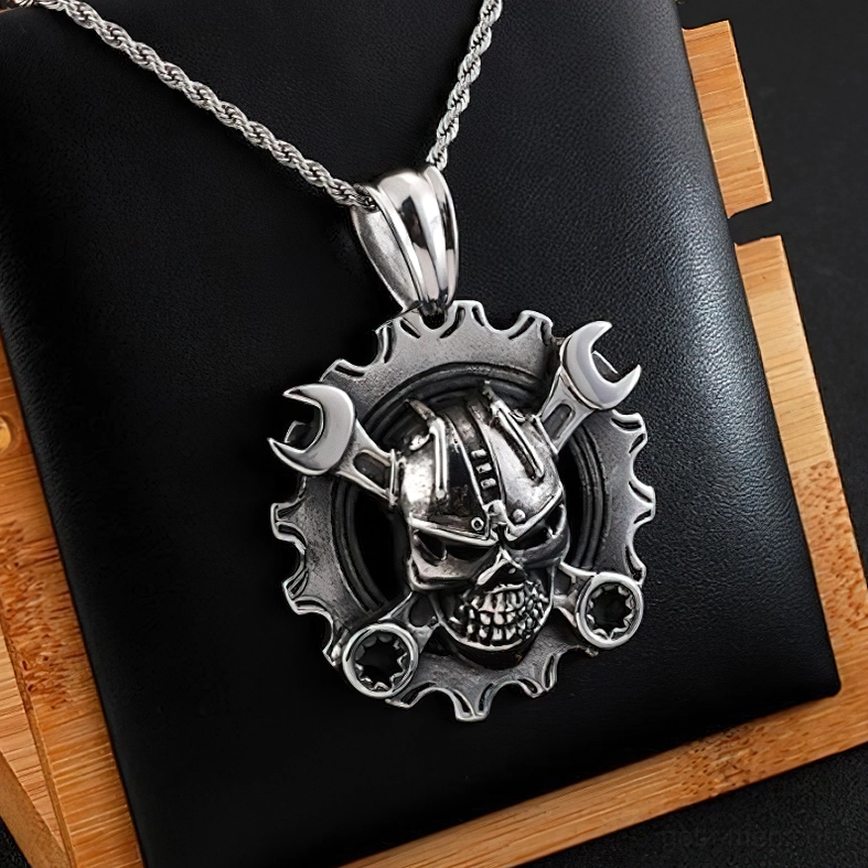 Compact mechanical skull gear pendant with necklace chain on leather wood background gothic aesthetic