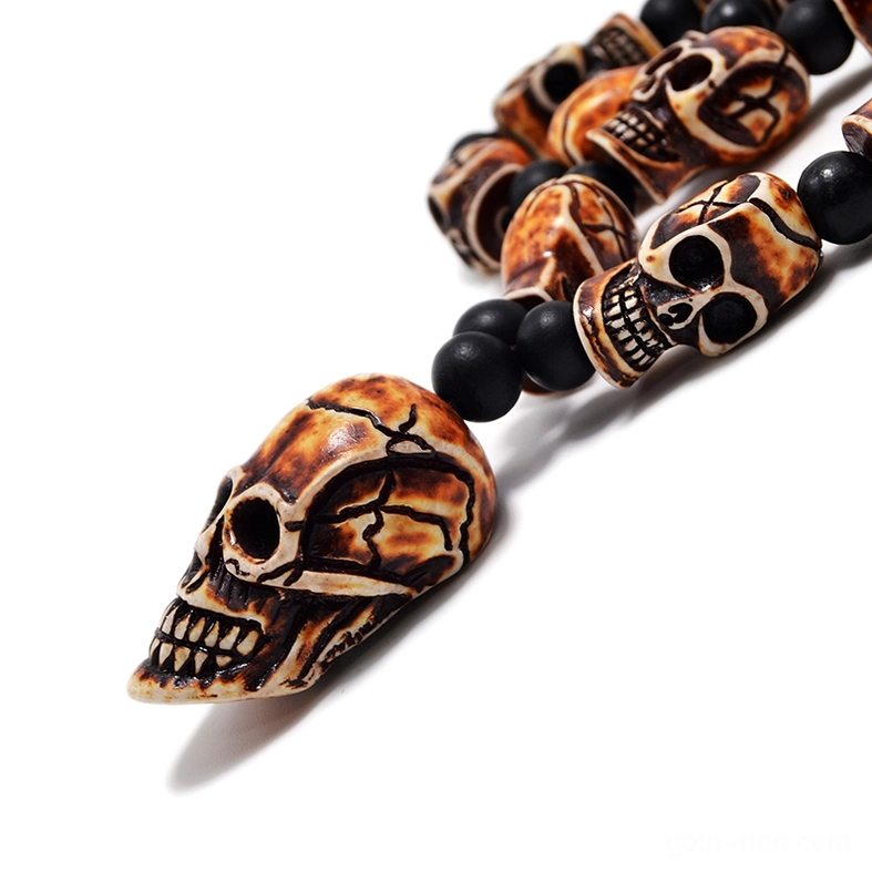 Side view elongated pointed skull pendant gothic necklace light tan beads
