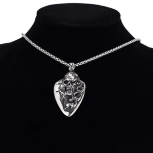 Gothic skull pendant worn on black jewelry mannequin torso, close-up detail of carved design