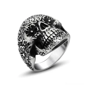 Memento mori skull ring with floral engraving, antique silver stainless steel gothic jewelry, front three-quarter view