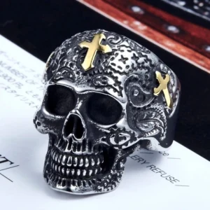 Detailed frontal view of vintage gothic sugar skull ring showing carved skull design, gold cross decorations, and intricate engraved floral patterns