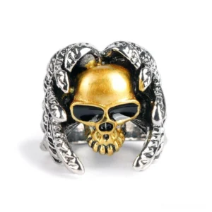 Gothic winged skull ring front view showcasing full gold skull with black enamel inlaid eyes and detailed feather wrap design