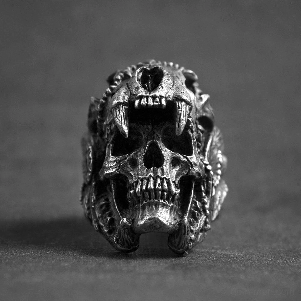 Direct frontal view of gothic skull biker ring with realistic saber-tooth fangs and sharp metal details