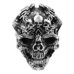 Multi-skull sterling silver gothic ring front view with intricate dragon carvings and antique finish on white background