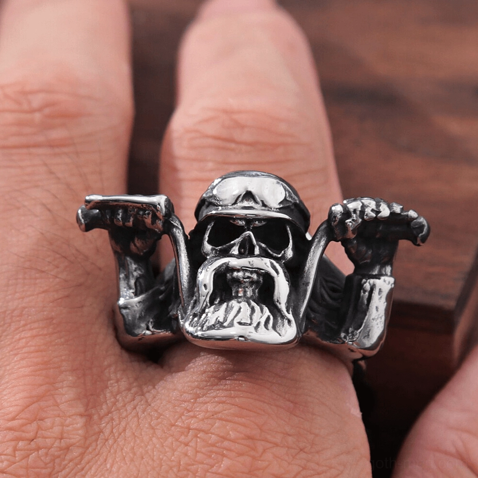 Gothic skull biker ring perfectly fitted on index finger dark wood background