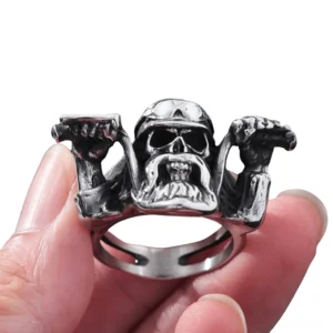 Bearded skull gripping motorcycle handlebars on gothic biker ring worn on finger