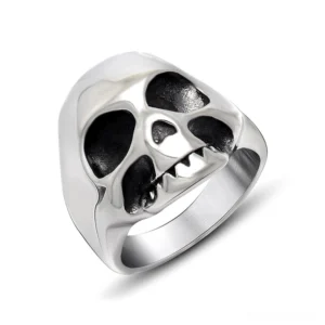 Gothic skull ring with carved fangs and hollowed eye sockets, polished silver stainless steel memento mori design, front three-quarter view