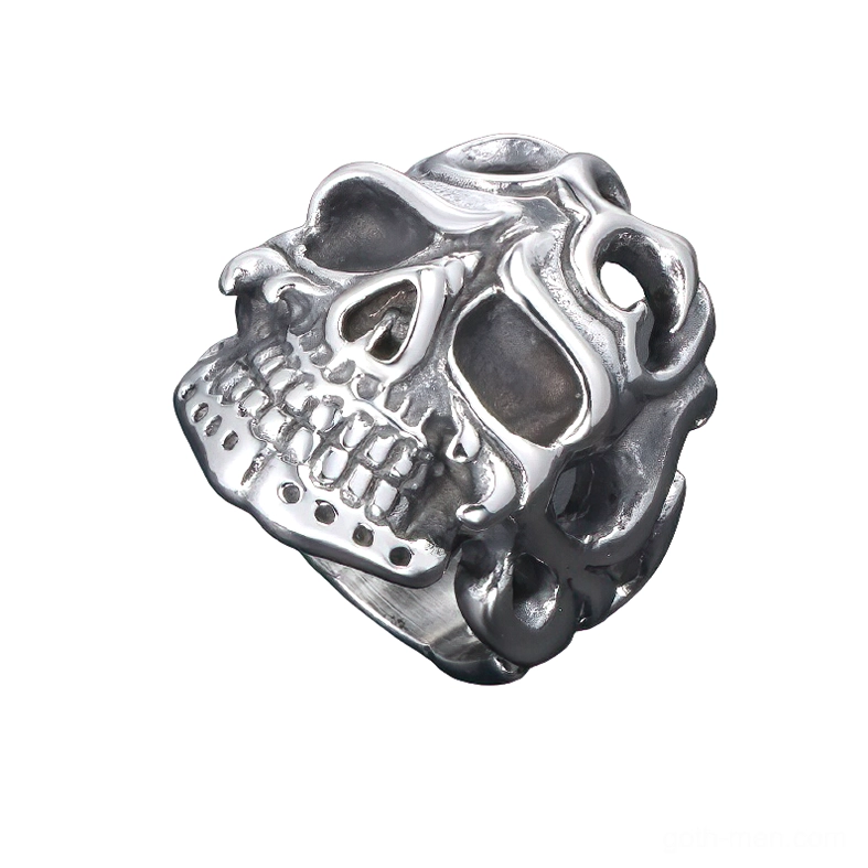 Top-down oblique angle of dark antique silver skull ring showing detailed skull teeth and hollow decorative carved cutouts