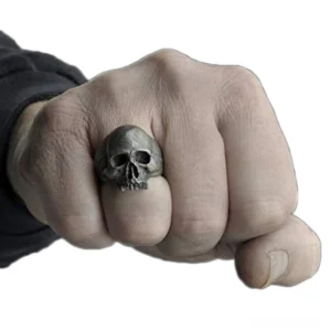 Gothic biker skull ring worn on male hand showing 3D skull design and vintage silver finish