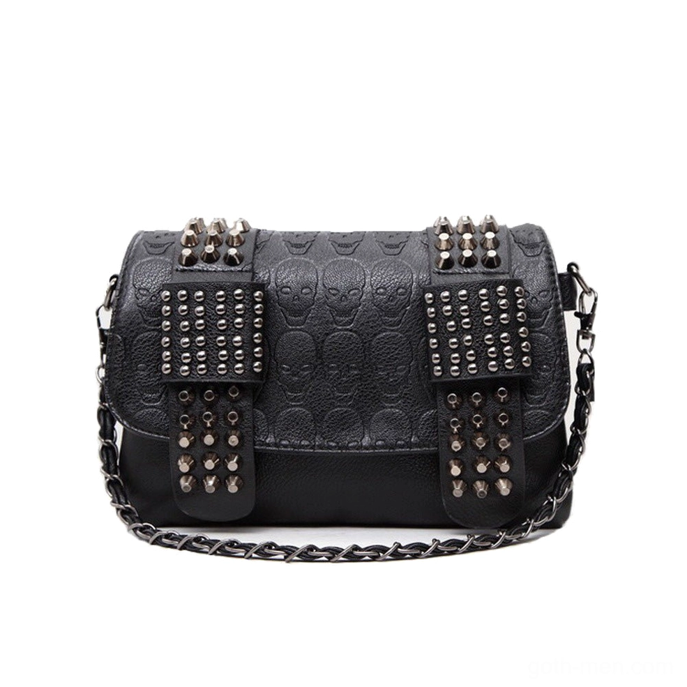 Black skull embossed rivet studded crossbody messenger bag front flat lay view with metal spike decorations and chain shoulder strap on white background