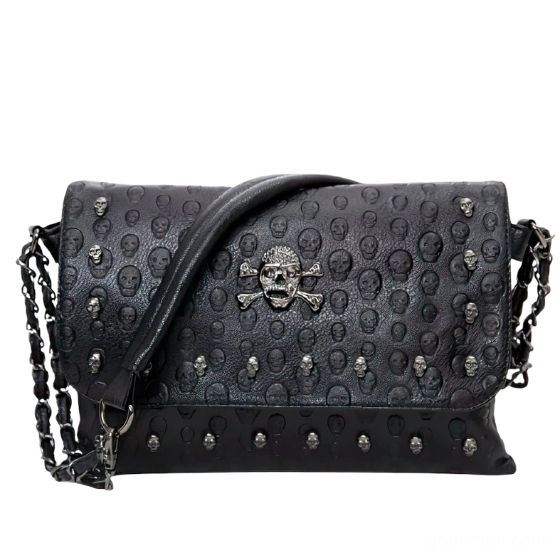 Black gothic leather shoulder bag front view with embossed skull pattern and metal rivet details, flat lay studio photography