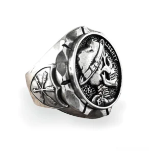 Gothic skull signet ring stainless steel left three-quarter view showing Liberty 1936 engraving and fedora-wearing skull design with cross shield band pattern