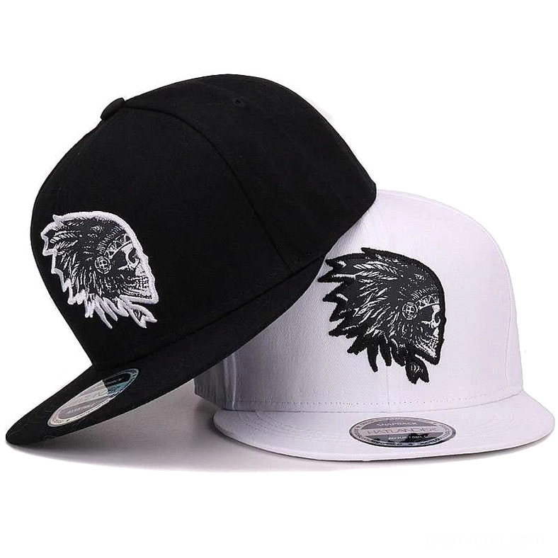 Gothic skull embroidered snapback cap in black and white colorways, flat brim design from side angle