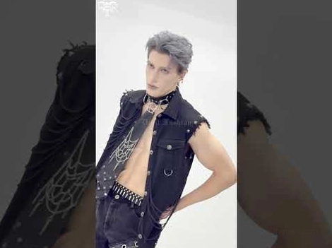 Black gothic sleeveless shirt with spiked accessories web embroidery and chain detailing on male model
