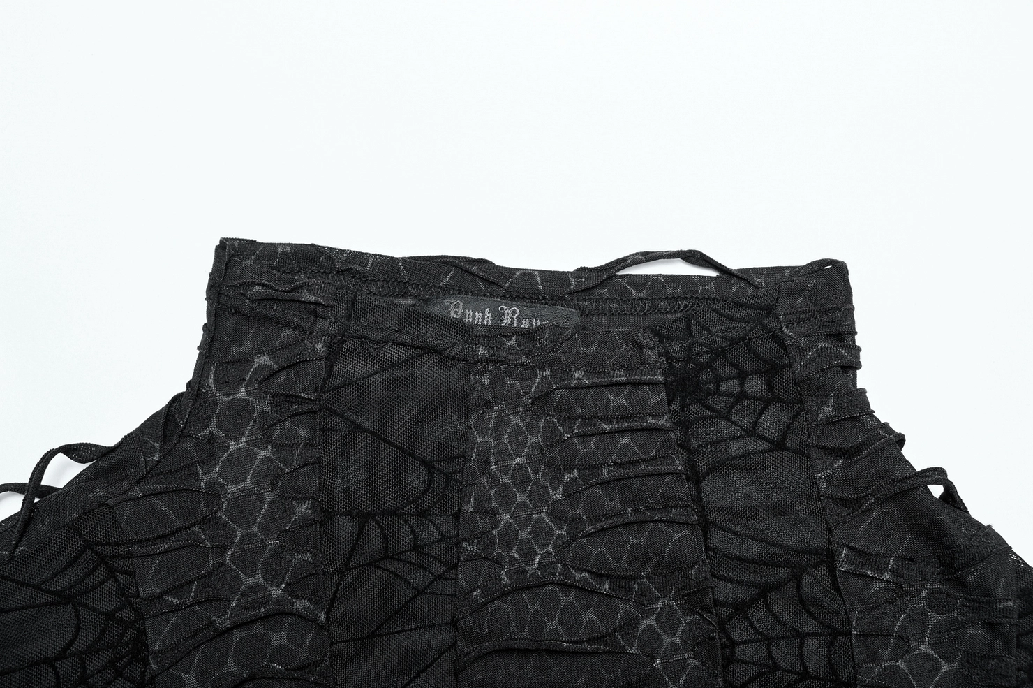 Gothic men's sleeveless top waist detail - black web mesh fabric close-up with brand label