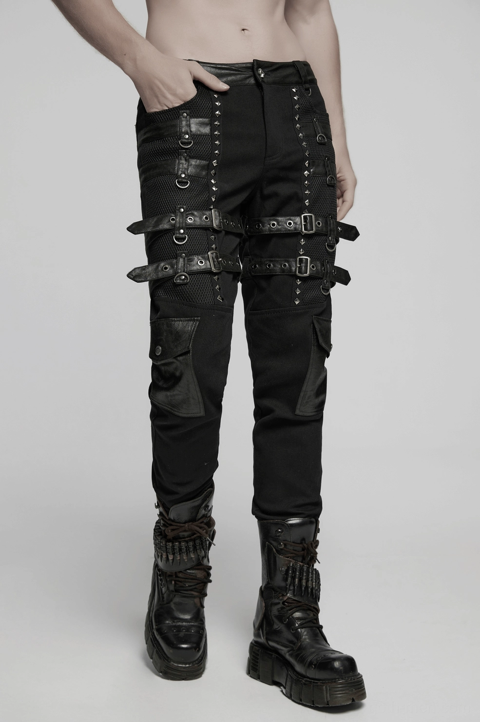 Gothic slim-fit studded combat pants displaying fitted silhouette and adjustable leg hardware from front angle