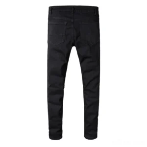 Black gothic distressed slim jeans back view showing dual patch pockets with rivets