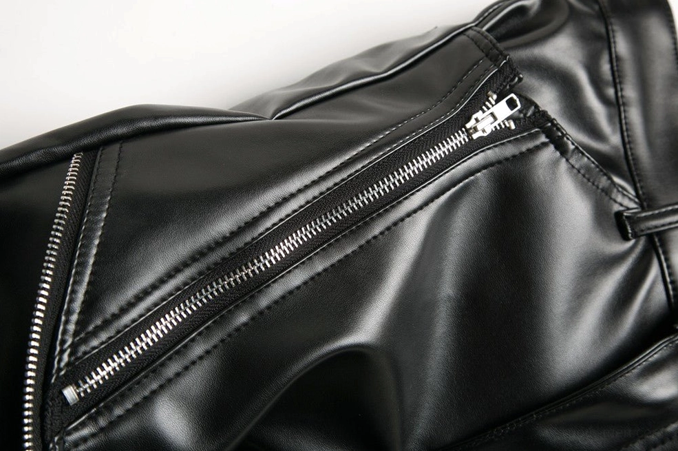 Front leg zipper pocket with extended metal zipper accent and topstitching on gothic biker pants