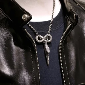 Vintage gothic cobra snake pendant necklace worn on male model with black leather jacket, antiqued silver finish close-up