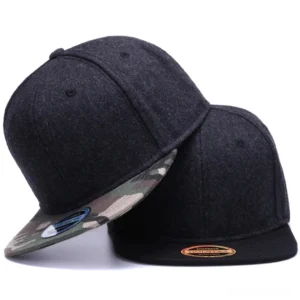 Two gothic wool snapback caps featuring black and camouflage colorways, oblique side view showcasing flat brim and adjustable back closure