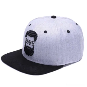 Embroidered mustache gothic snapback cap front three-quarter view showing 3D embroidered FREEDOM text and beard design on grey crown with black brim