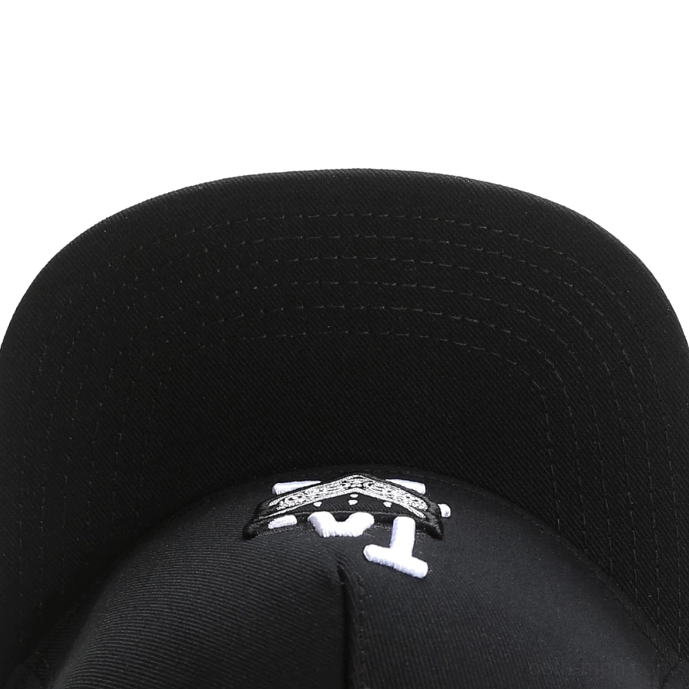 Close-up of gothic cap interior crown showing embroidery detail and neat reinforced stitching seams