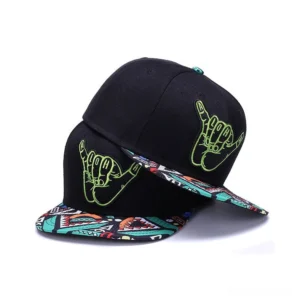 Gothic black snapback cap with lime green hand-embroidered shaka logo and geometric patterned brim, tilted three-quarter view