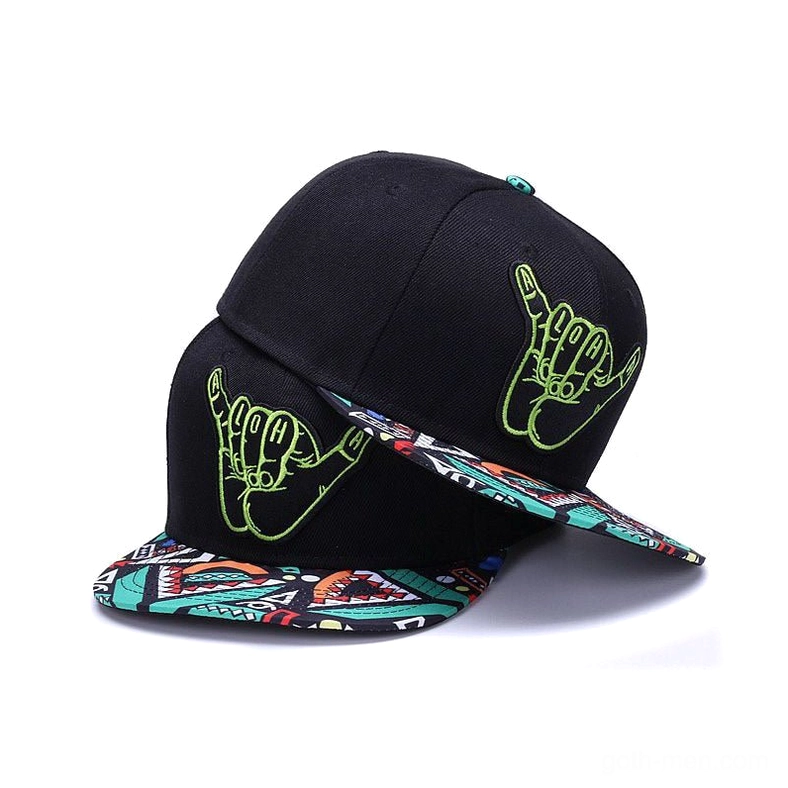 Gothic black snapback cap with lime green hand-embroidered shaka logo and geometric patterned brim, tilted three-quarter view