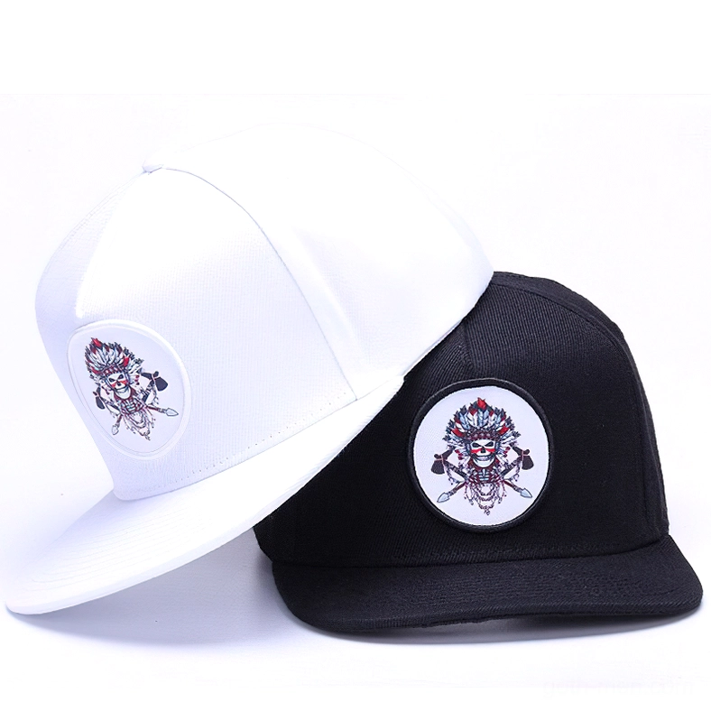 Two gothic skull snapback caps in black and white displayed together, three-quarter oblique perspective with matching embroidered skull patches