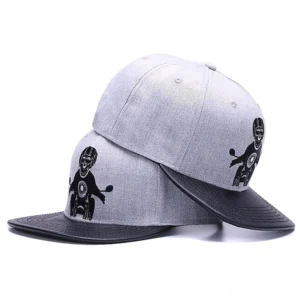 Multiple grey gothic baseball caps stacked side by side displaying embroidered skull rider motorcycle motif
