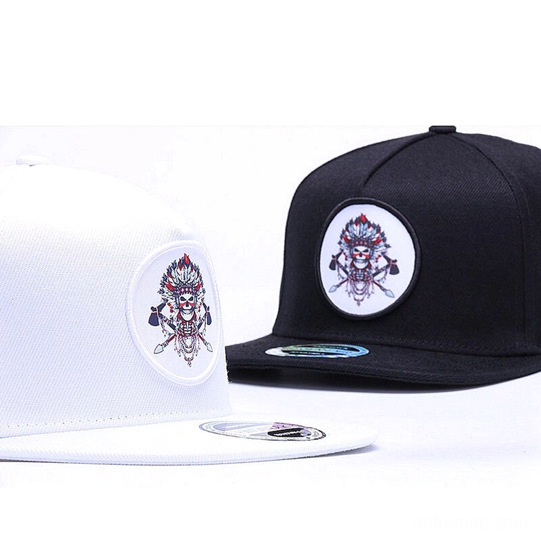 White and black gothic snapback caps three-quarter angle with visible brand sticker on white cap, showcasing alternative streetwear aesthetic
