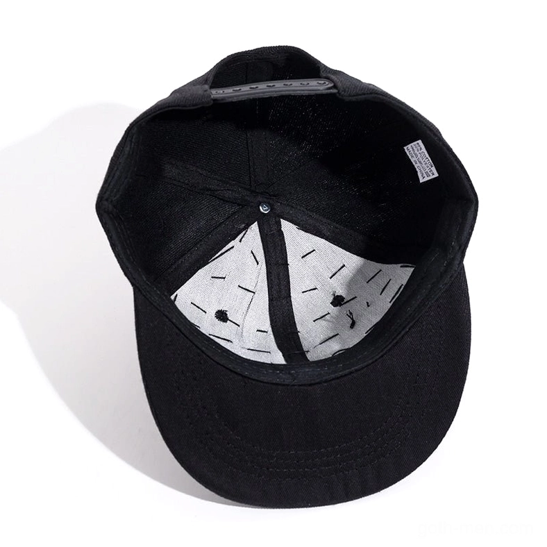 Interior view of gothic spike snapback showing black sweatband, snap closure mechanism, and size label