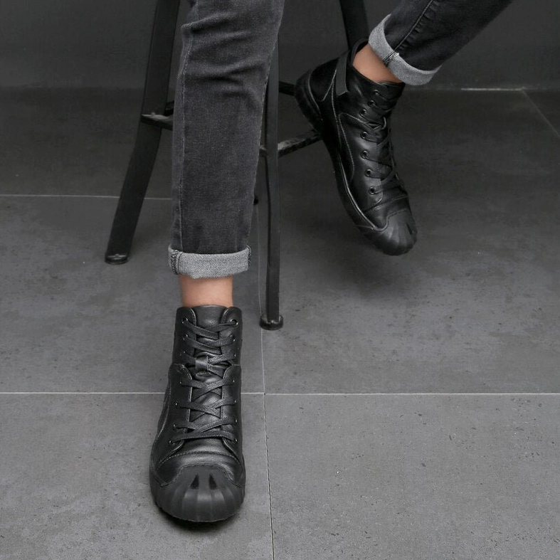 Black leather high-top gothic sneakers on male model with cuffed denim and rolled jeans alternative fashion