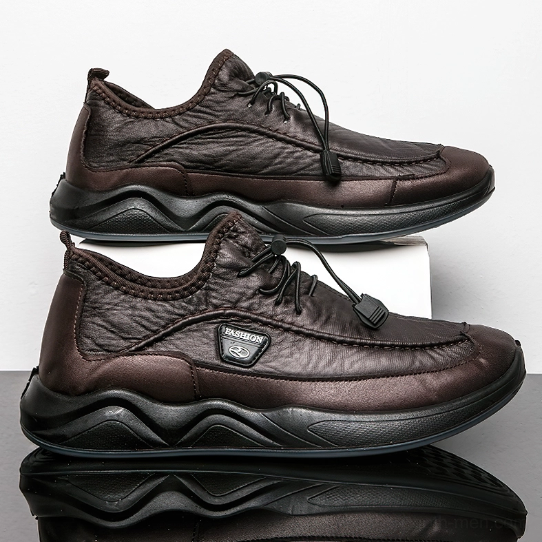 Brown leather gothic sneaker showing wavy thick non-slip outsole and structured construction