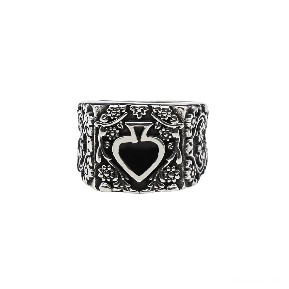 Heart-shaped spade signet ring front flat lay, white background showing engraved floral frame and silver band details