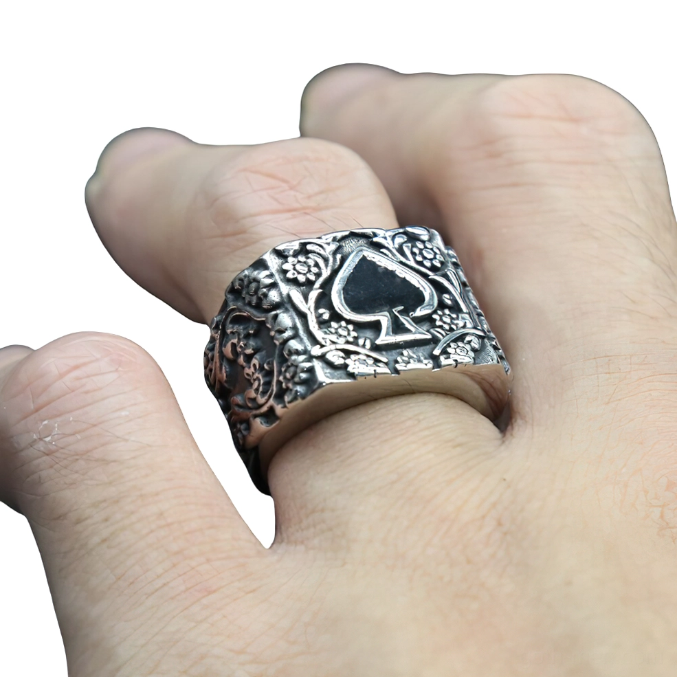 Gothic spade signet ring worn on male hand, close-up finger view showing embossed floral details and authentic wear appearance