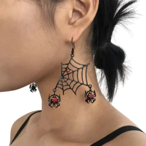 Black spider web dangle earrings with red rhinestone accents worn on model, close-up side view showing gothic jewelry details