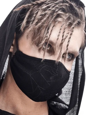 Male model with dreadlocks wearing breathable black spiderweb gothic face mask, close-up front view studio shot