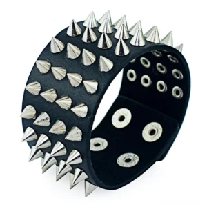 Black PU leather gothic spike bracelet with four rows of cone spikes, closeup oblique view showing adjustable snap holes and silver metal details