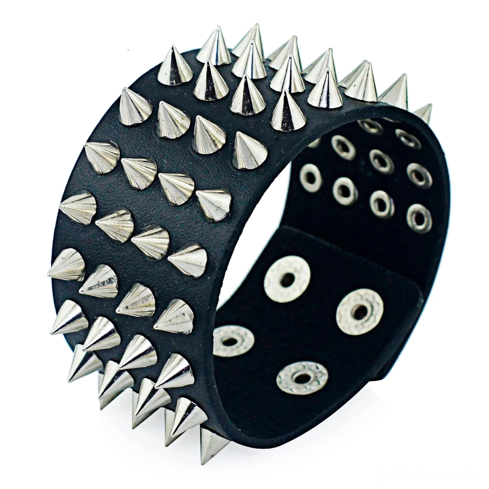 Black PU leather gothic spike bracelet with four rows of cone spikes, closeup oblique view showing adjustable snap holes and silver metal details