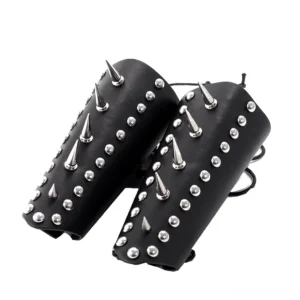 Pair of matching black leather studded wrist guards with dual lace-up fasteners, flat lay top-down view showing symmetrical stud arrangement
