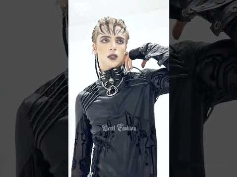 Male model wearing black spike leather choker with metal chain details, half-body stylized dark background