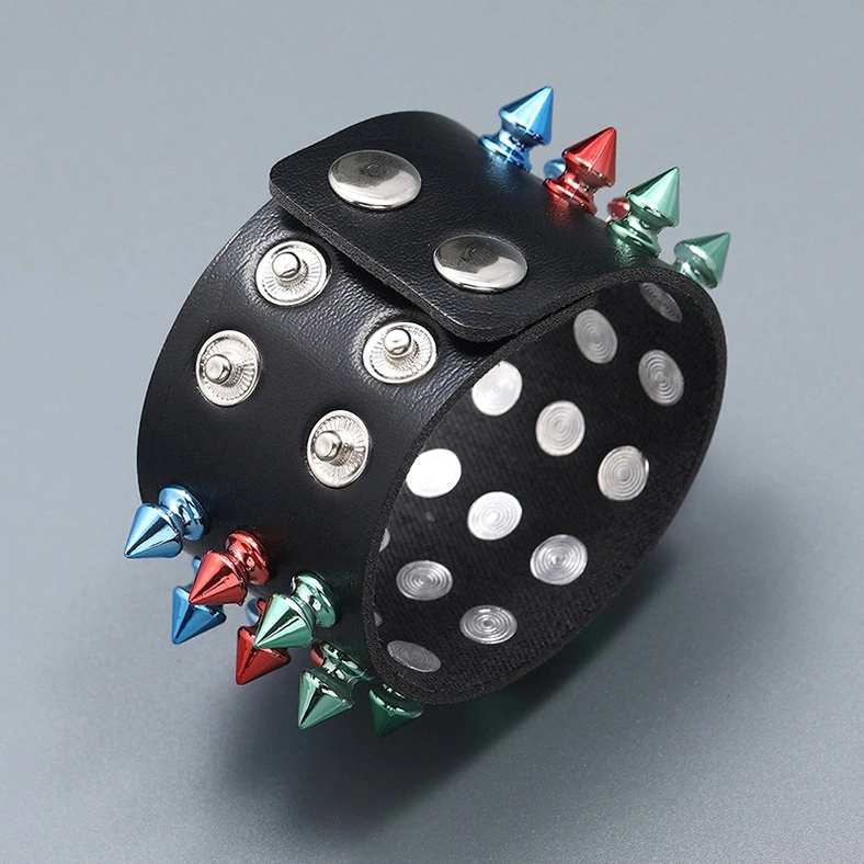 Three-quarter view of multicolor spike gothic cuff showing both outer and inner sides with metal cone spikes