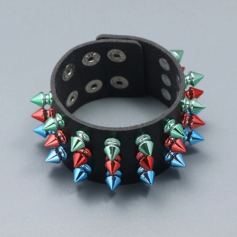 Inner side of gothic spike leather cuff bracelet showing snap fastener closure and three-row spike construction