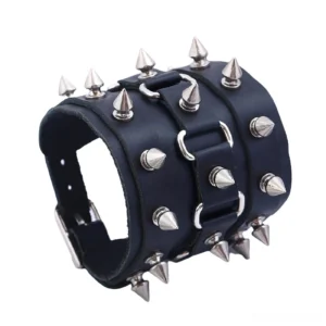 Side oblique angle of spiked leather cuff bracelet showing dense cone spike arrangement and adjustable strap hardware