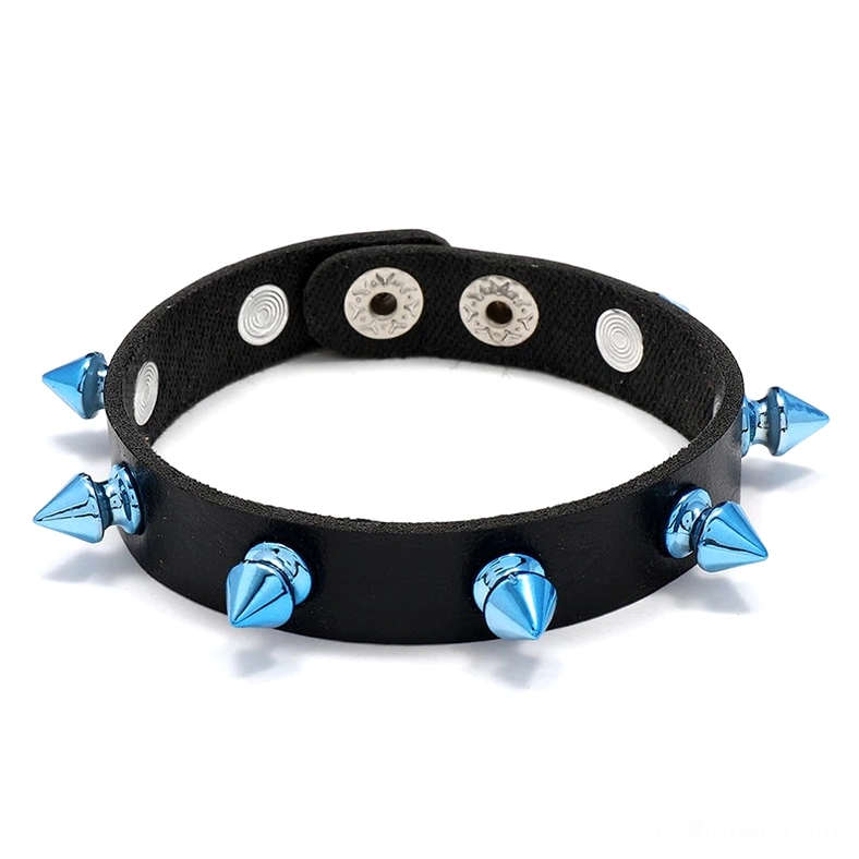 Blue spike gothic leather cuff bracelet flat lay with conical metal rivets, overhead view on white background